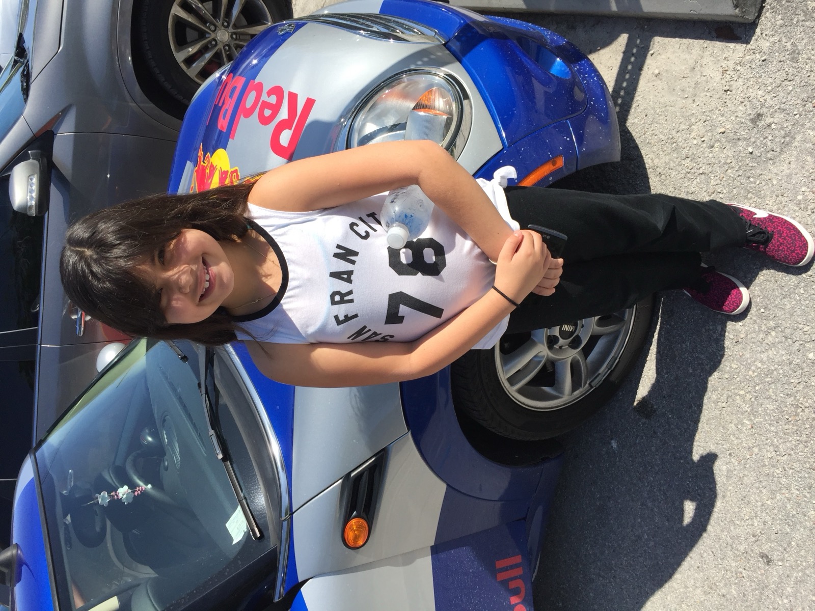 Sofia by a race car